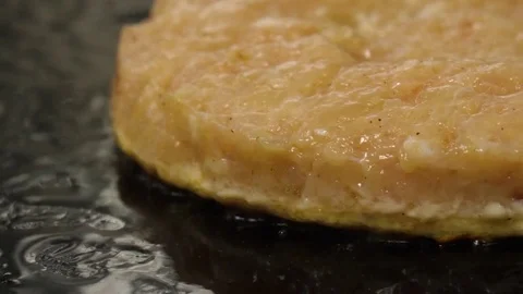 Cooking burger on the hot plate, camera moves to right, bubbling oil Stock Footage 76897622