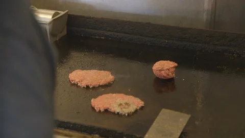 Cooking burger patties Stock Footage 104873244