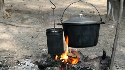 Cooking on burning campfire Stock Footage 67538949