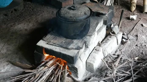 Cooking by burning fire using a traditional stove, Stock Footage 300858172