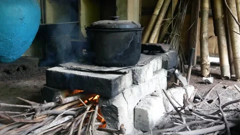 Cooking by burning fire using a traditional stove, Stock Footage 300858201