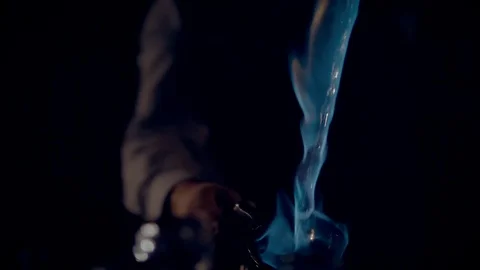 Cooking a burning punch or grog, close-up. A fiery stream pours from cup to cup. Stock Footage 124269017