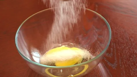 Cooking cake baker in the kitchen. close-up bowls with egg yolk where sugar is Stock Footage 147536922