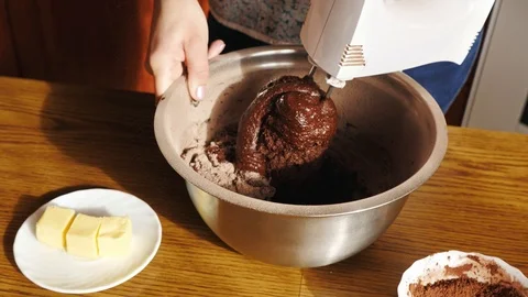 Cooking cake. Close-up view of mixing chocolate dough in a bowl Stock Footage 86234418
