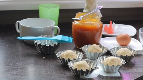 Cooking cake. On the table are baking dishes. They put the dough. Nearby are  Stock Footage 104968208