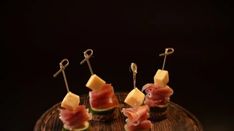 Cooking canapes, bread, cheese, jamon, ham, cucumber, canapes on skewers Stock Footage 148620087