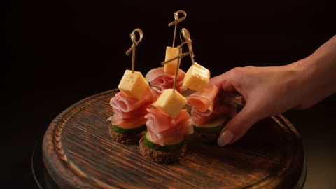 Cooking canapes, bread, cheese, jamon, ham, cucumber, canapes on skewers Stock Footage 148620593