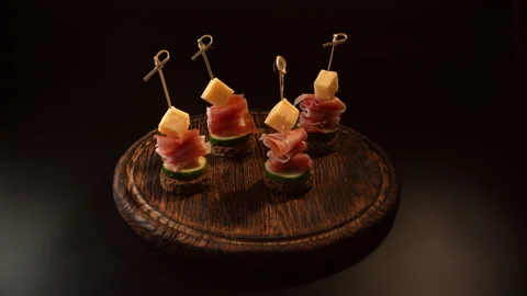 Cooking canapes, bread, cheese, jamon, ham, cucumber, canapes on skewers Stock Footage 148621569