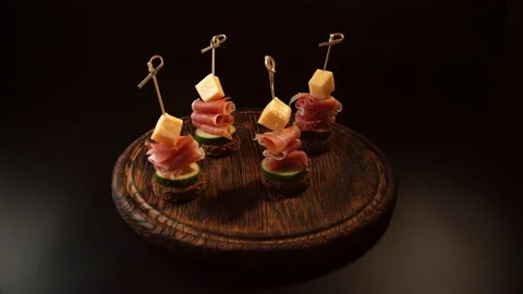 Cooking canapes, bread, cheese, jamon, ham, cucumber, canapes on skewers Video stock 148621676
