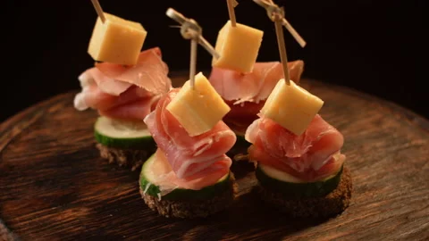 Cooking canapes, bread, cheese, jamon, ham, cucumber, canapes on skewers rotates Stock Footage 148632290