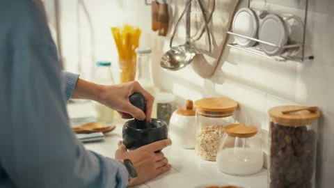 Cooking with care while preparing ingredients in a cozy kitchen setting Stock Footage 323733453