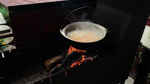 Cooking cauldron hanging over a fire. Thick fire smoke, orange flame. Stock Footage 167857787