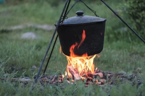 Cooking in cauldron on the open fire . Stock Photos