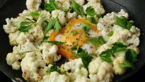 Cooking cauliflower and fried egg in a ring of bell pepper Stock Footage 314993205