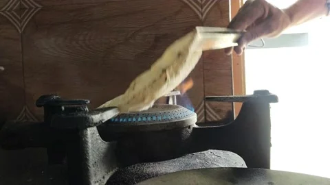 Cooking chapati indian bread on fire Stock Footage 238743334