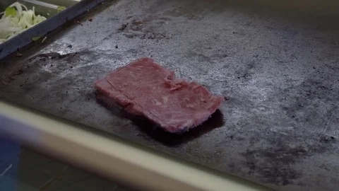 Cooking a cheese steak on a griddle Stock Footage 78094628