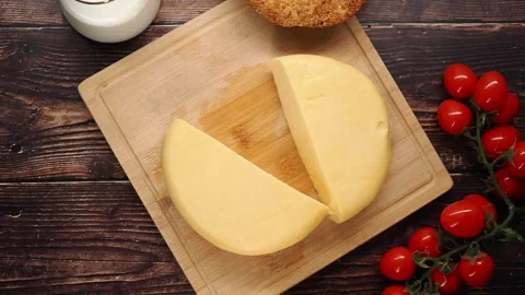 Cooking cheese with tomatoes and bread on a wooden board Stock Footage 339646647