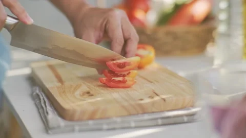 Cooking - Chefs hands are cutting tomatoes on the chopping board. Stock Footage 242342453