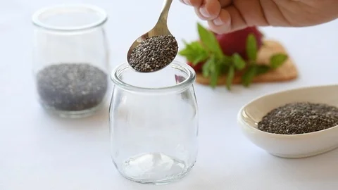 Cooking Chia Pudding: Putting Chia Seeds in a jar Stock Footage 111429621