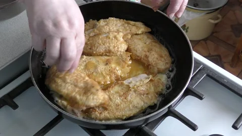 Cooking chicken breast in a pan Stock Footage 208867760