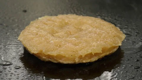 Cooking chicken burger, chef adds oil on the frying surface, 4K 60 FPS Stock Footage 76897567