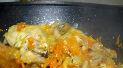Cooking chicken in a cauldron Stock Footage 60235084