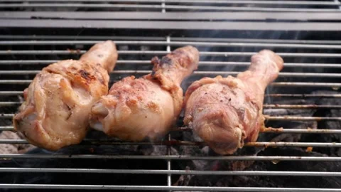 Cooking chicken legs on open fire Stock Footage 276376105