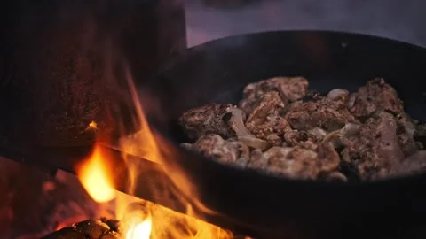 Cooking Chicken over Open Fire: Rustic Cuisine Stock Footage 284674028