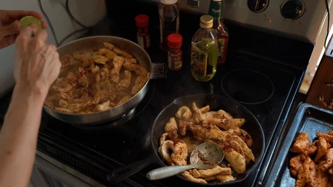 Cooking chicken in pan and adding lyme juice. Stock Footage 95685983