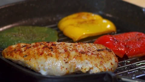 Cooking chicken with vegetables in a pan Stock Footage 76794855