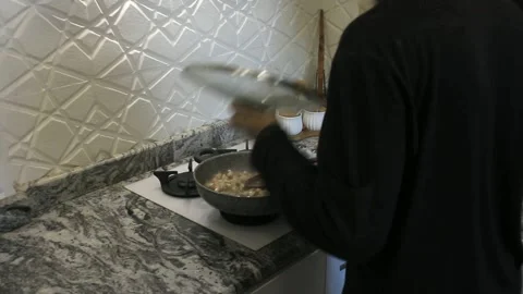 Cooking chiken in th kitchen with steam and big pan Stock Footage 162913612