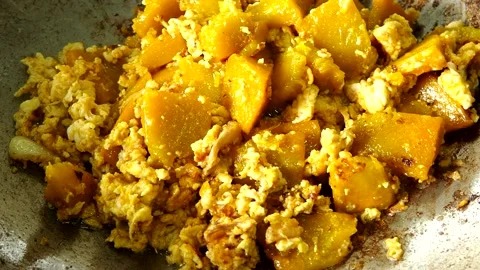 Cooking chopped pumpkins with egg in pan , indoor Chiangmai Thailand. Stock Footage 204844542
