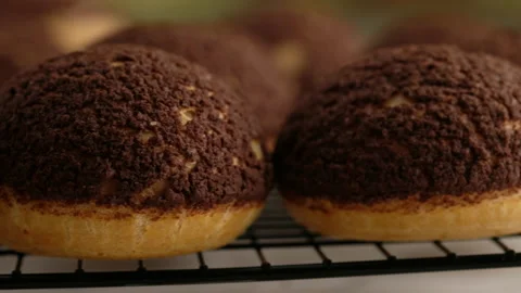 Cooking choux or profiteroles, ready choux on wire rack, close-up. Cooking Stock Footage 141763399