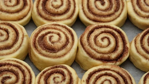 Cooking cinnamon rolls or Cinnabon close up. raw cinnamon buns Stock Footage 143401025