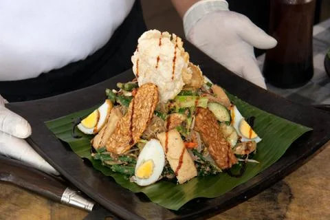 Cooking class, ready dish served on a plate in the cook hands. Indonesia Bali Stock Photos