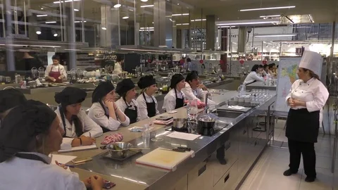 Cooking class, trainees learning in the kitchen culinary profession, to be chefs Stockbeeldmateriaal 69883612