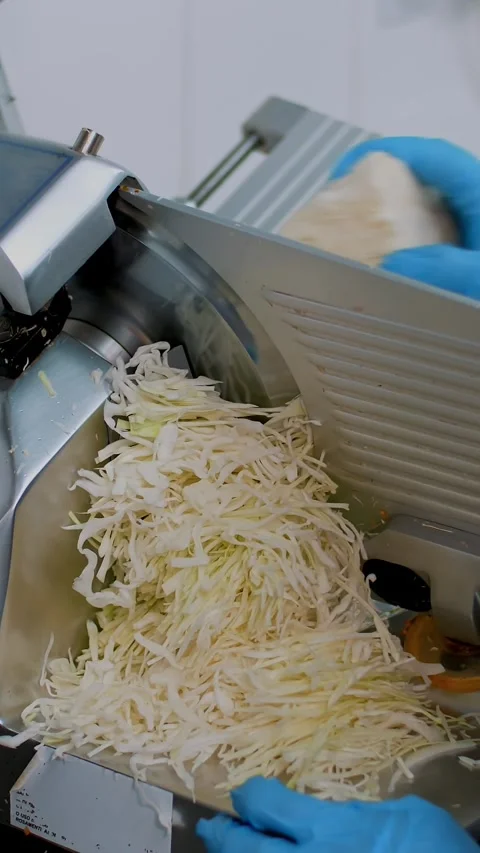 Cooking. close-up. cuisine worker, in protective gloves, cuts fresh cabbage on Stock Footage 319939551