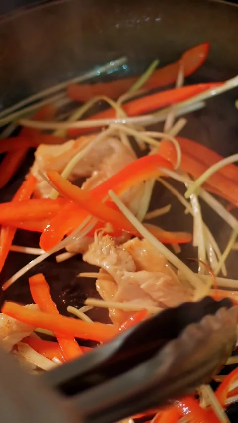 Cooking. close-up. pieces of meat with vegetables are fried in a pan. top view. Stock Footage 319990895