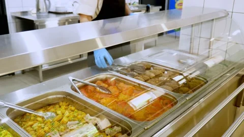 Cooking. close-up. the waiter, in protective gloves , opens containers with Stock Footage 138176132