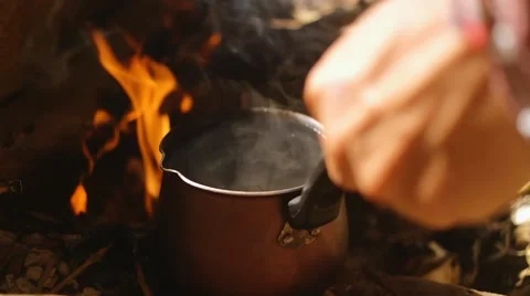 Cooking coffee on a campfire in the foggy forest. Coffee is boiling on the 스톡 동영상 59348888