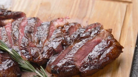 Cooking concept. Grilled marinated beef flank steak on wooden board Stock Footage 99551406