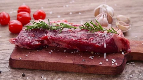 Cooking concept. Raw beef steak on a wooden table. Stock Footage 123334027