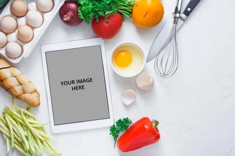Cooking concept, tablet computer and breakfast ingredient on white bacjground Stock Photos