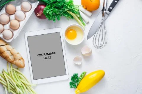 Cooking concept, tablet computer and breakfast ingredient on white bacjground Stock Photos