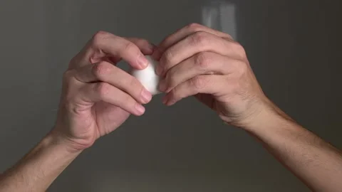 Cooking. Cooking breakfast. Cracking egg. The egg breaks into the camera lens.  Stock Footage 144804457