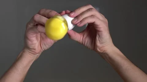 Cooking. Cooking breakfast. Cracking egg. The egg breaks into the camera lens. Stock Footage 144805122