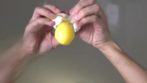 Cooking. Cooking breakfast. Cracking egg. The egg breaks into the camera lens. Video stock 144805235