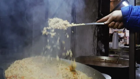 Cooking. Cooking pilau Stock Footage 100740023