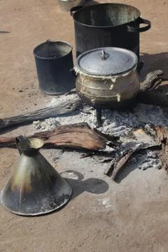 Cooking corn cereal in contrule on fire in the village, Botswana. Stock Photos