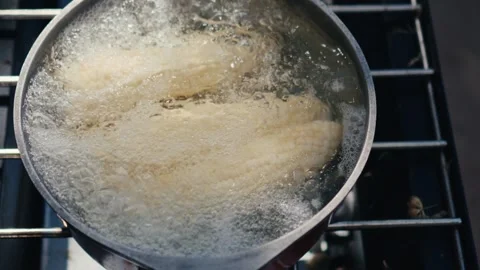 Cooking corn on the cob outside in summer Stock Footage 303046352